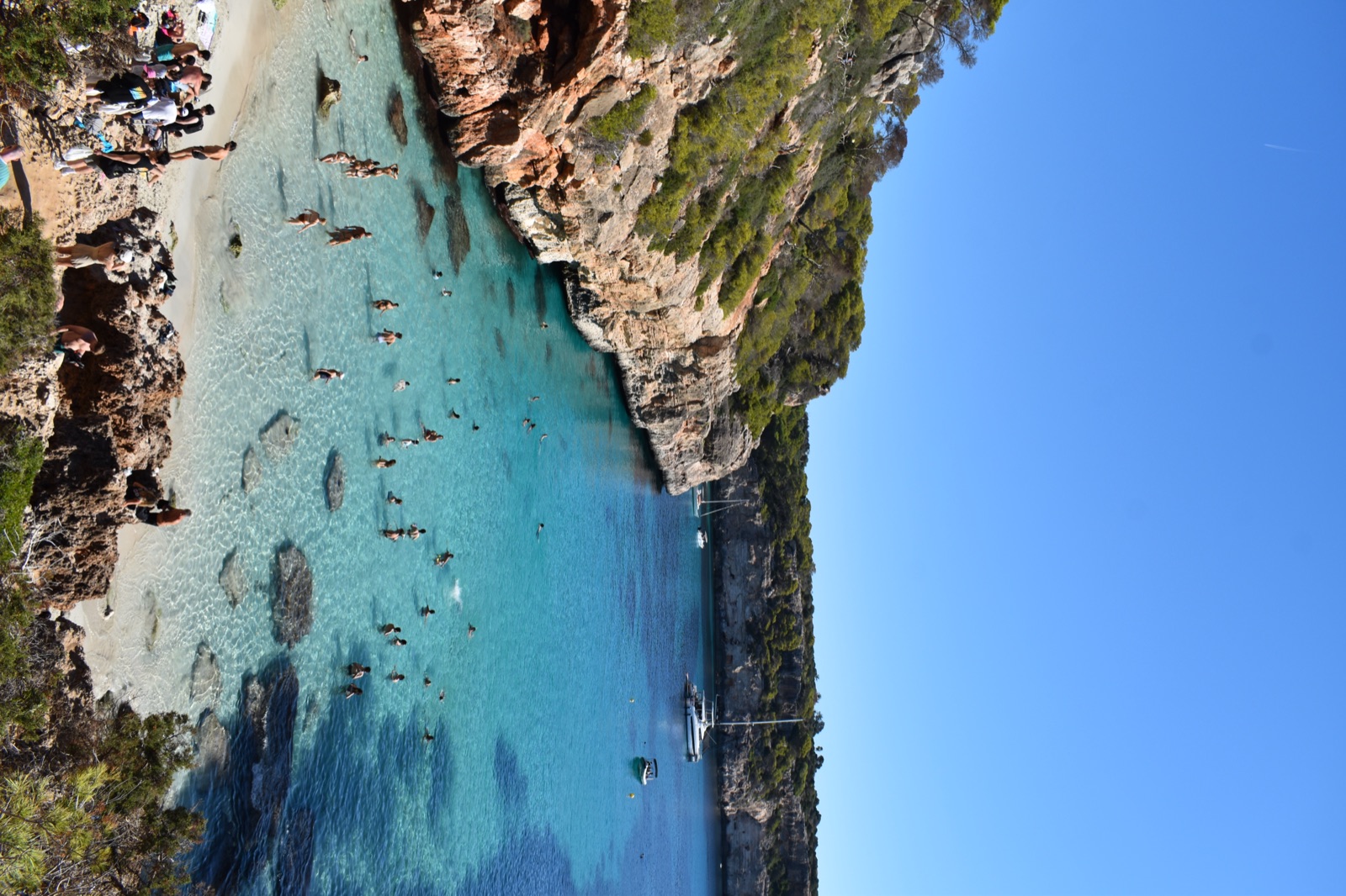 A turquoise cove ringed by cliffs in Mallorca.